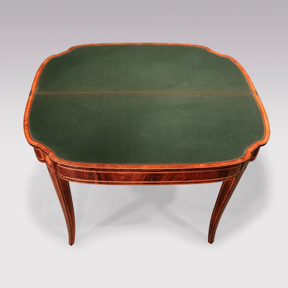 An antique Sheraton period rosewood fold-over card table featuring intricate marquetry stringing, diamond inlay accents, and tapered legs. View III