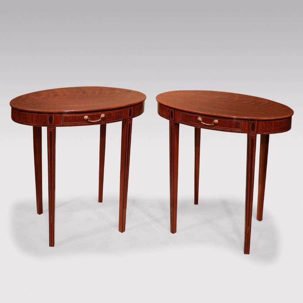 A pair of late 18th-century mahogany oval occasional tables featuring satinwood stringing, single frieze drawers with brass handles, and square tapered legs. View II