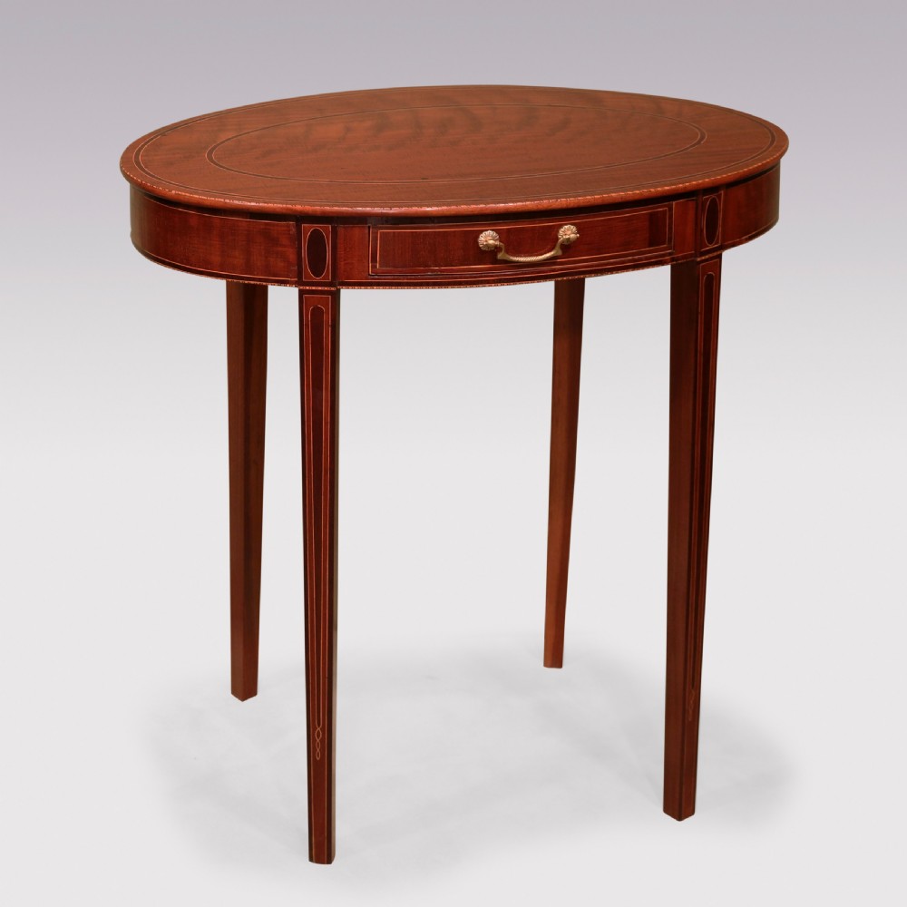 A pair of late 18th-century mahogany oval occasional tables featuring satinwood stringing, single frieze drawers with brass handles, and square tapered legs. View IV
