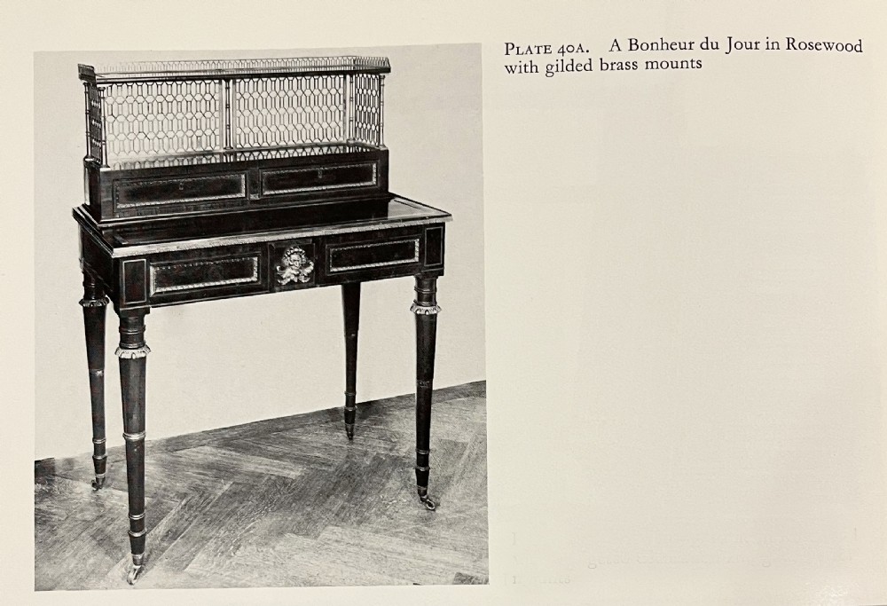 An early nineteenth-century rosewood bonheur du jour writing desk featuring a pierced brass gallery top, small drawers, brass mounts, and turned legs with castors. View VIII