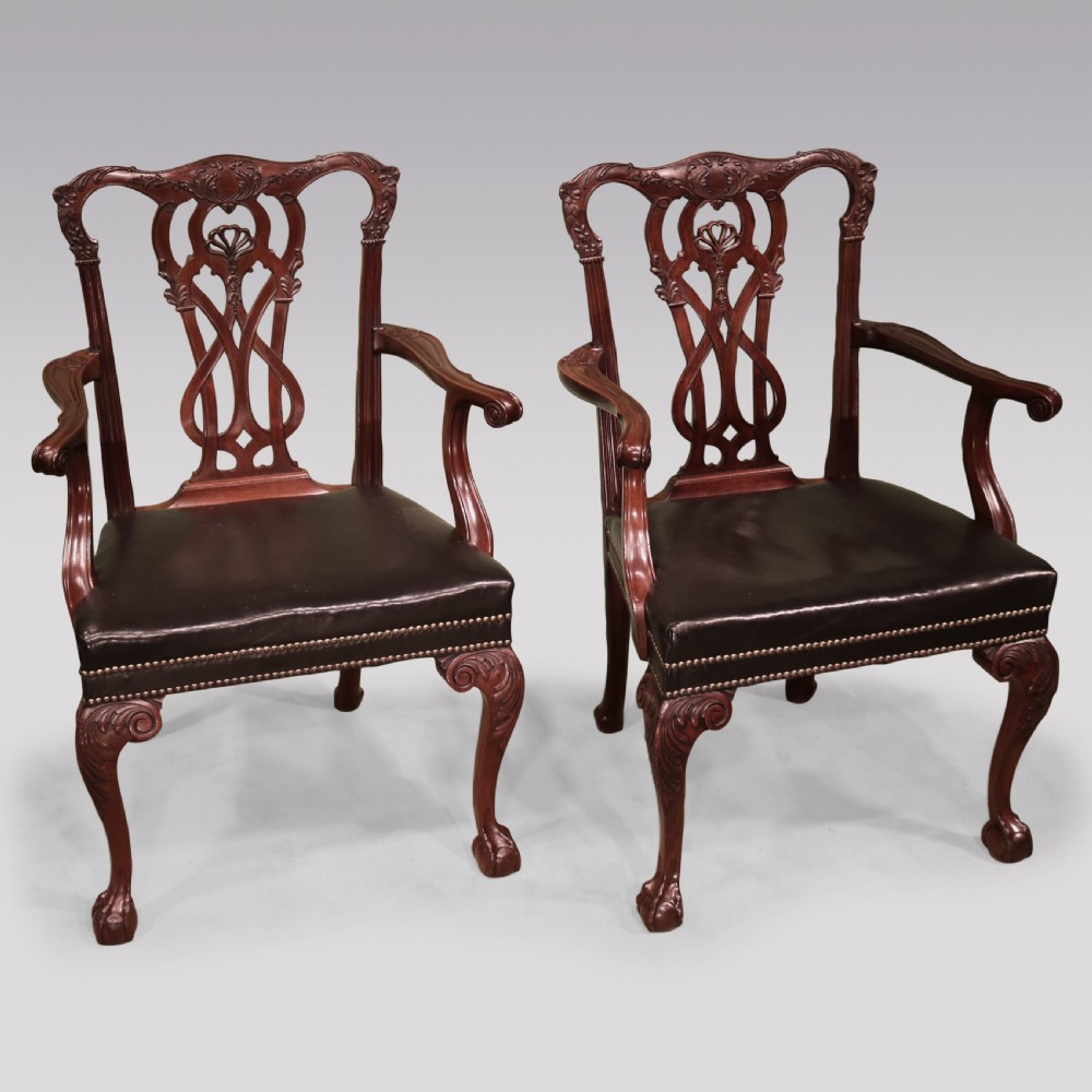 A set of eight mahogany dining chairs comprising six side chairs and two carvers with intricate pierced back splats, dark leather seats, and carved cabriole legs ending in ball and claw feet. View III