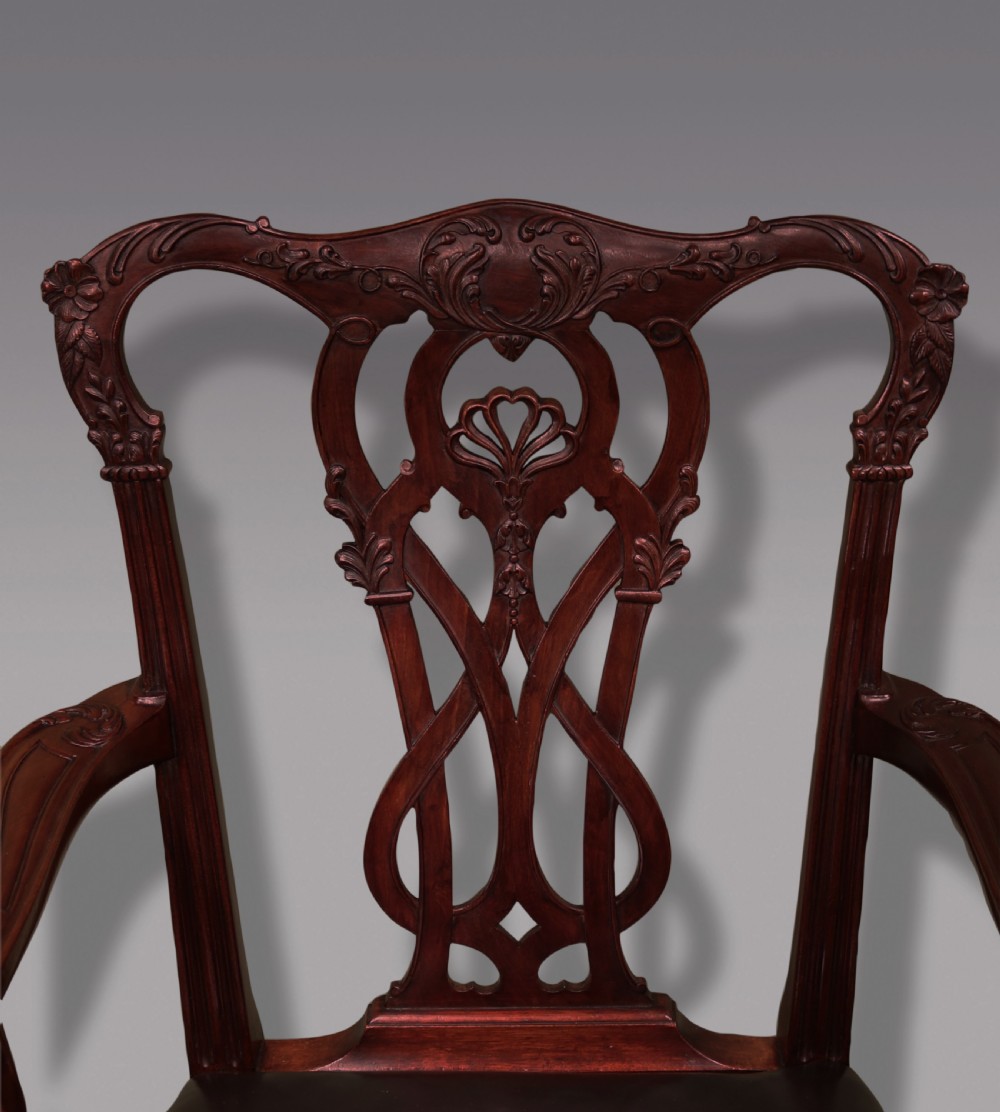 A set of eight mahogany dining chairs comprising six side chairs and two carvers with intricate pierced back splats, dark leather seats, and carved cabriole legs ending in ball and claw feet. View IV