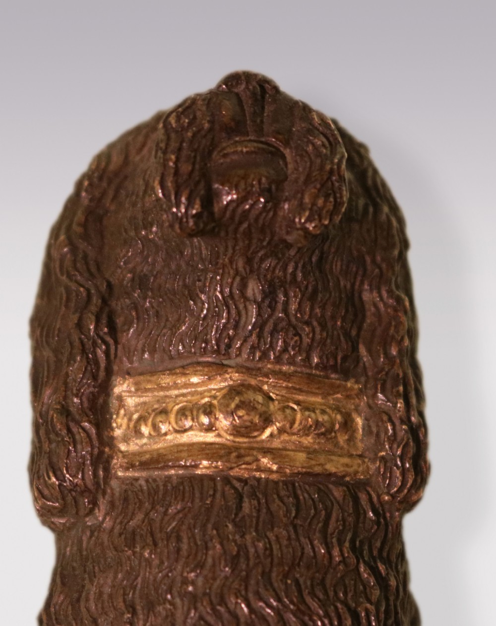 A pair of early 19th-century dark brown bronze poodle figures featuring gilded collars standing on rectangular bases. View IV