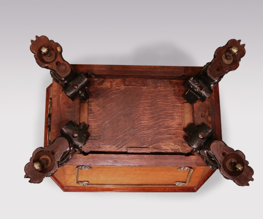 A Regency mahogany cellarette featuring tapered sides, brass inlay, brass lion mask handles, and carved claw feet. View VI