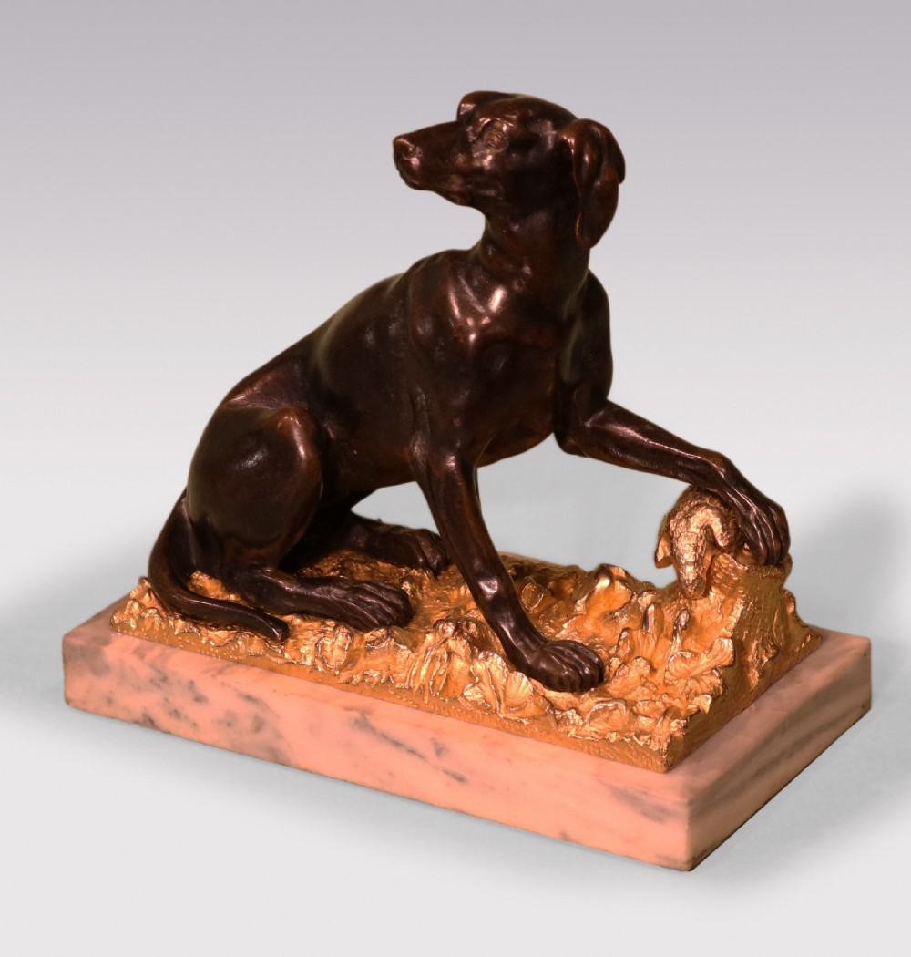 A pair of 19th-century dark bronze sculptures featuring seated hounds resting their paws on gilded ormolu bases depicting pheasants, mounted on rectangular marble plinths. View III