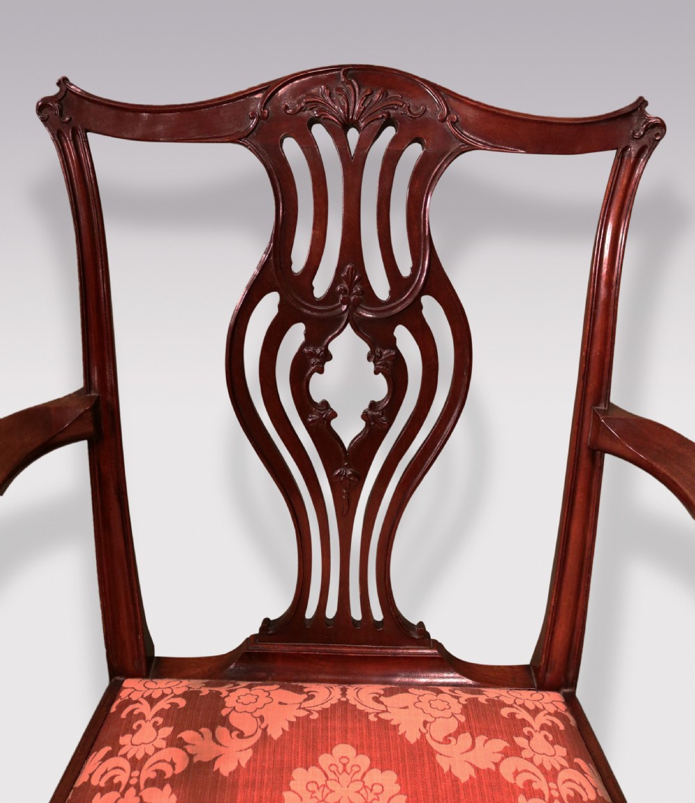 An 18th-century Chippendale carved mahogany armchair featuring a scrolled pierced splat, serpentine top rail, curved arms, and a patterned red damask seat. View II