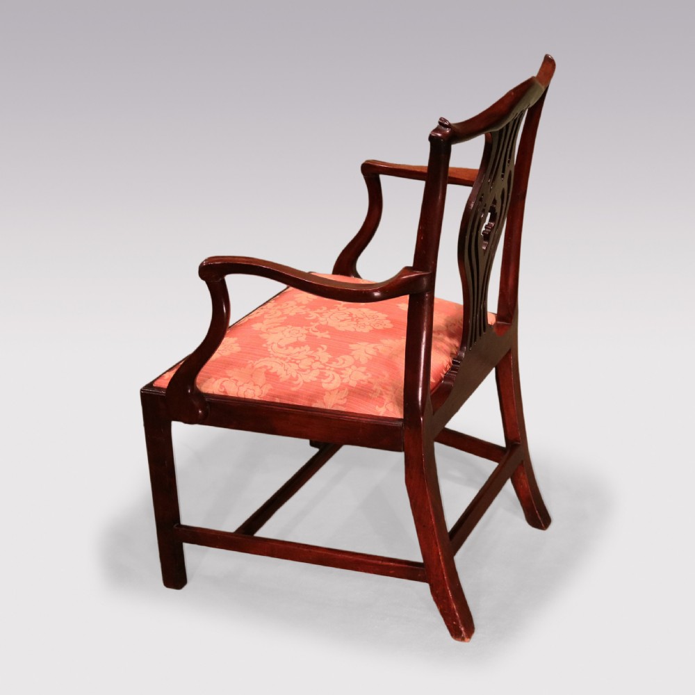 An 18th-century Chippendale carved mahogany armchair featuring a scrolled pierced splat, serpentine top rail, curved arms, and a patterned red damask seat. View IV