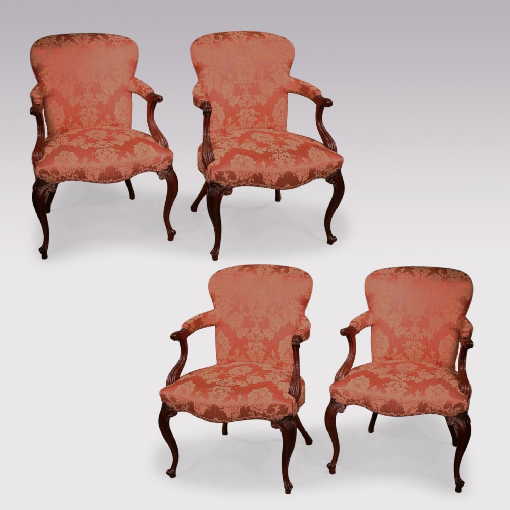 A set of four Hepplewhite period mahogany armchairs upholstered in coral red damask fabric with carved cabriole legs. View II