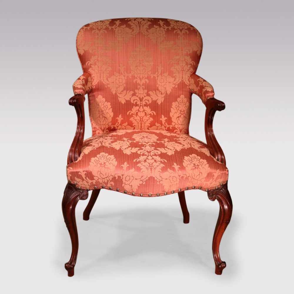 A set of four Hepplewhite period mahogany armchairs upholstered in coral red damask fabric with carved cabriole legs. View IV