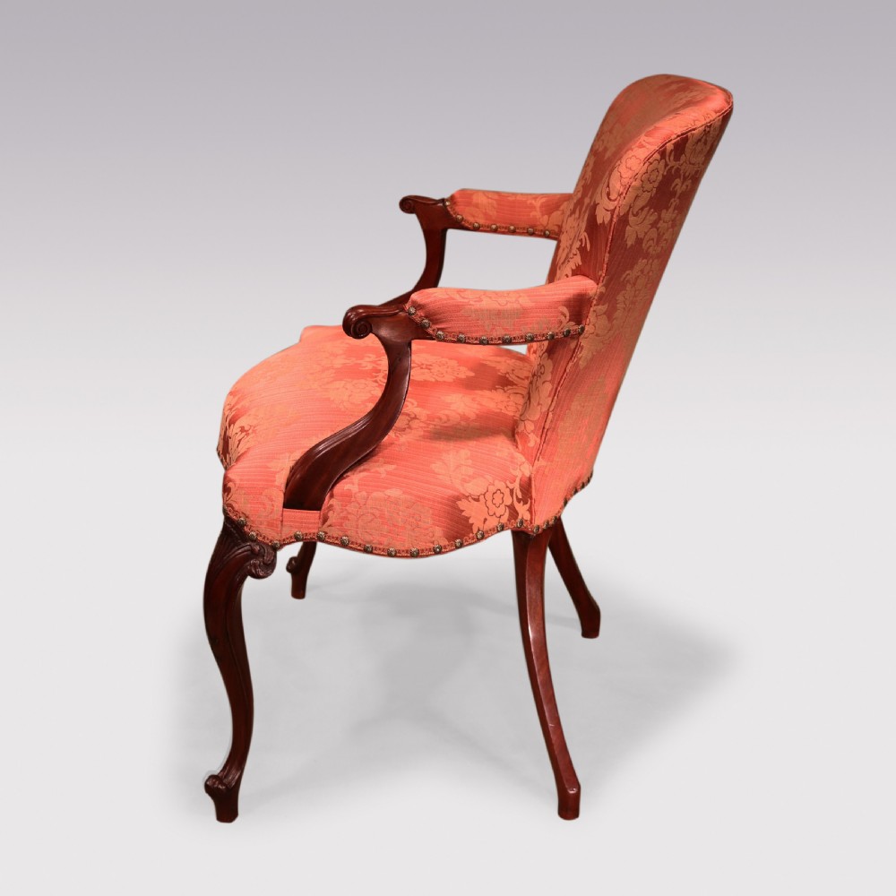 A set of four Hepplewhite period mahogany armchairs upholstered in coral red damask fabric with carved cabriole legs. View V