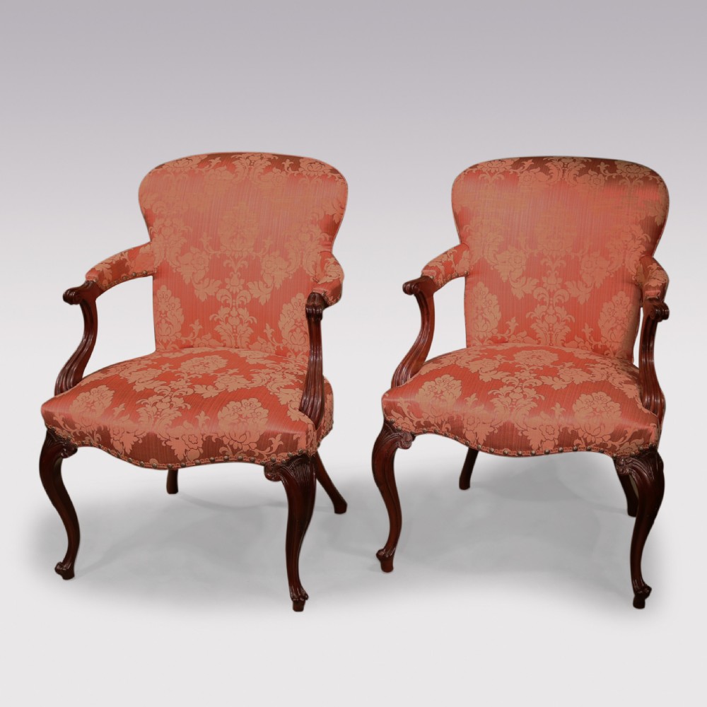 A set of four Hepplewhite period mahogany armchairs upholstered in coral red damask fabric with carved cabriole legs. View IX