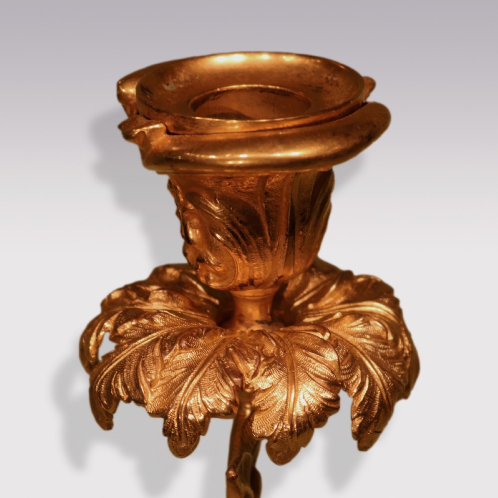 A pair of mid-19th century dark patinated bronze storks standing on rocky gilt ormolu bases, each holding a palm-leaf sconce in its beak. View IV