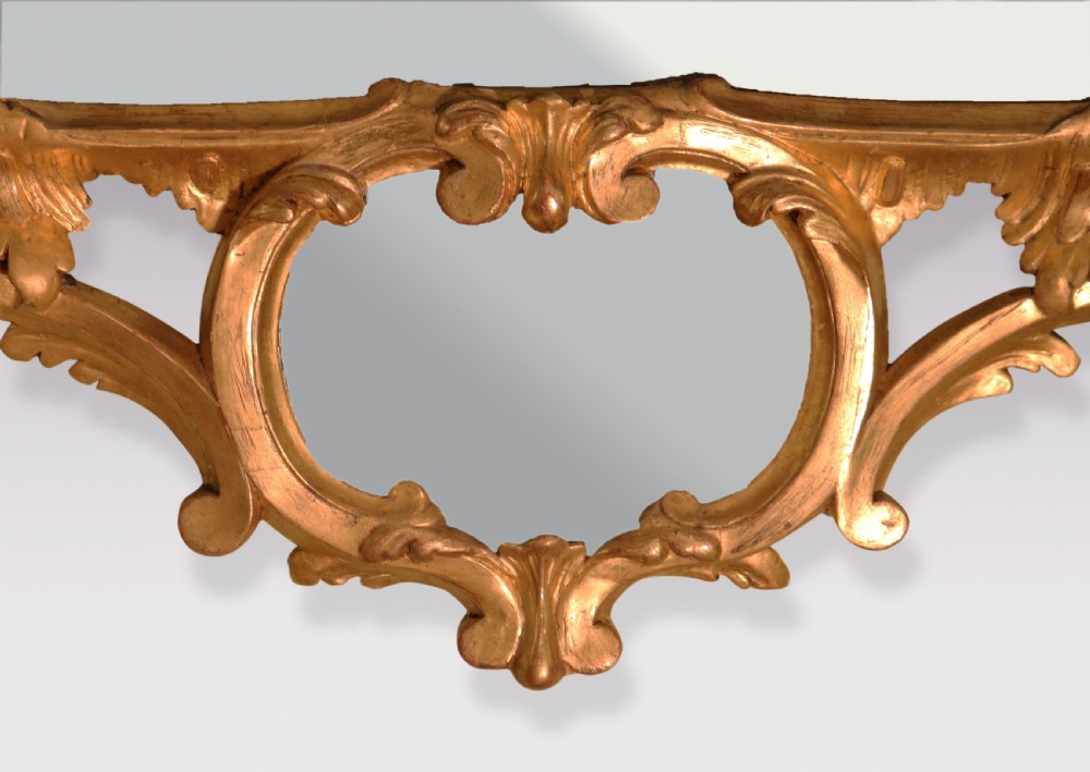 An antique Chippendale period rectangular wall mirror featuring an ornate carved giltwood frame with rococo scrollwork and foliage motifs. View IV