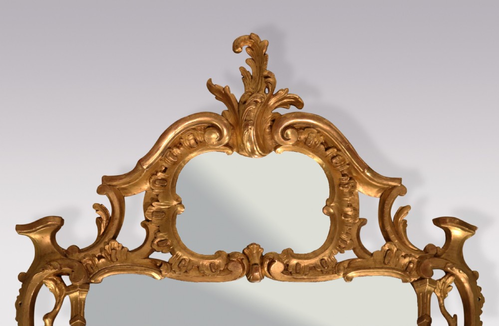 An antique Chippendale period rectangular wall mirror featuring an ornate carved giltwood frame with rococo scrollwork and foliage motifs. View V