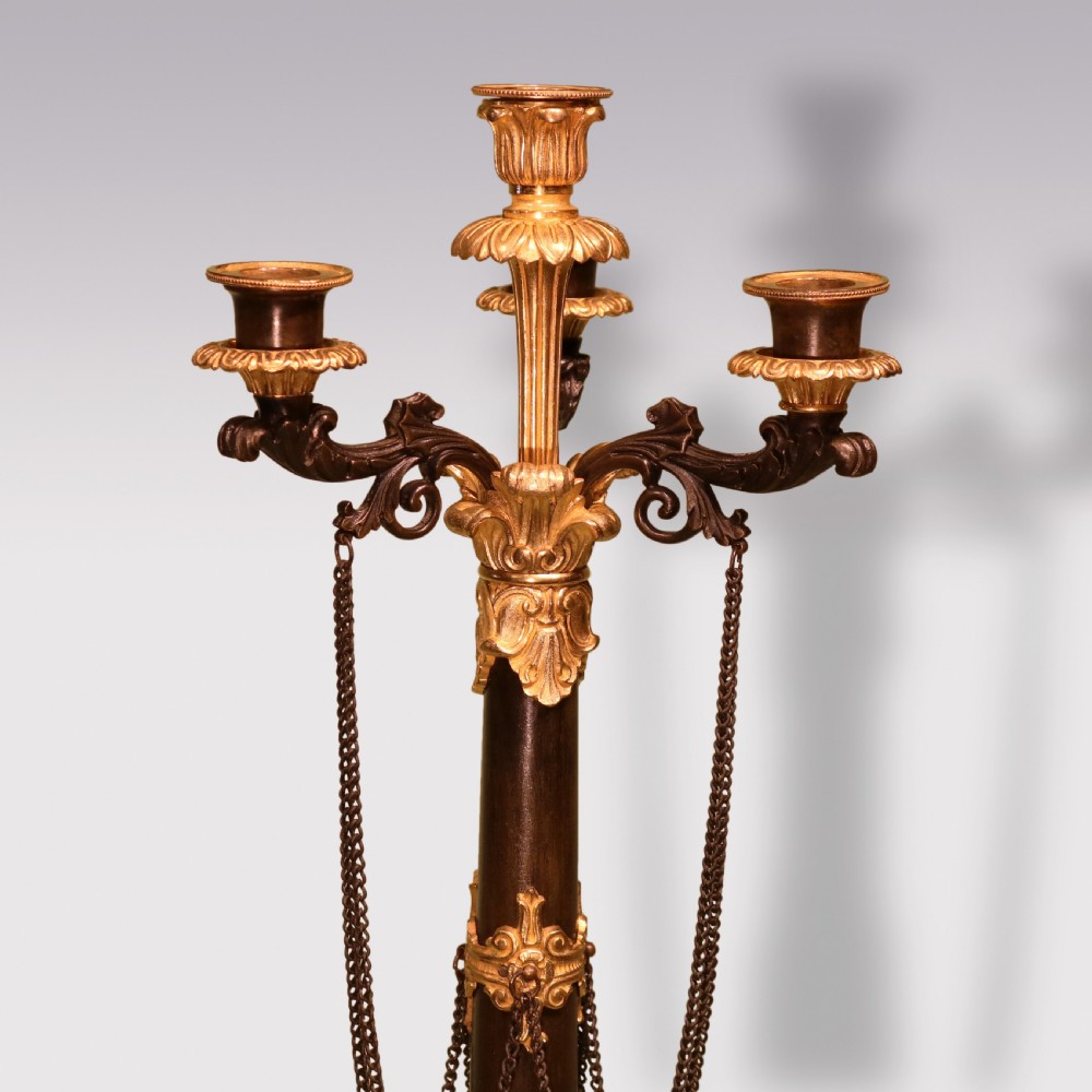 A pair of 19th-century French dark patinated bronze and gilt ormolu five-light candelabra with draped metal chains and scrolled bases. View III