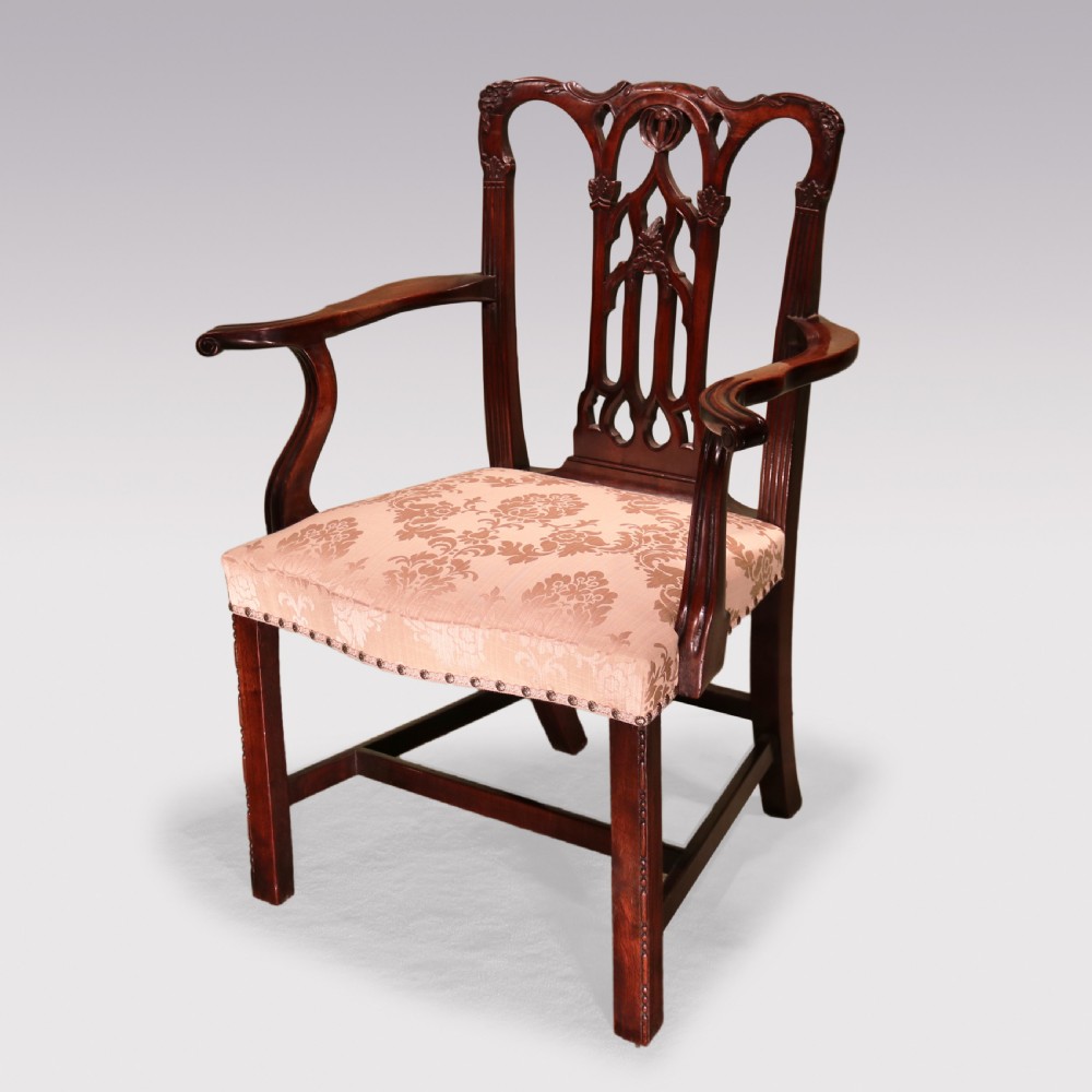 A set of twelve mid-nineteenth-century mahogany dining chairs with pierced Gothic tracery back splats and upholstered damask seats. View III