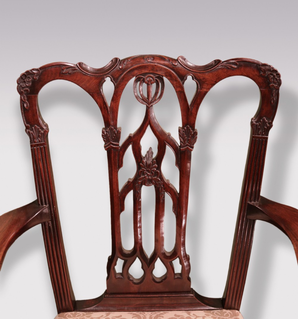A set of twelve mid-nineteenth-century mahogany dining chairs with pierced Gothic tracery back splats and upholstered damask seats. View IV