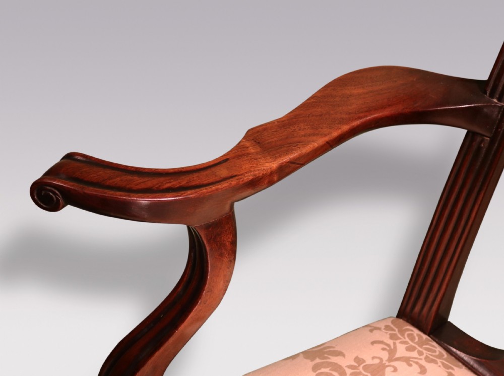 A set of twelve mid-nineteenth-century mahogany dining chairs with pierced Gothic tracery back splats and upholstered damask seats. View V