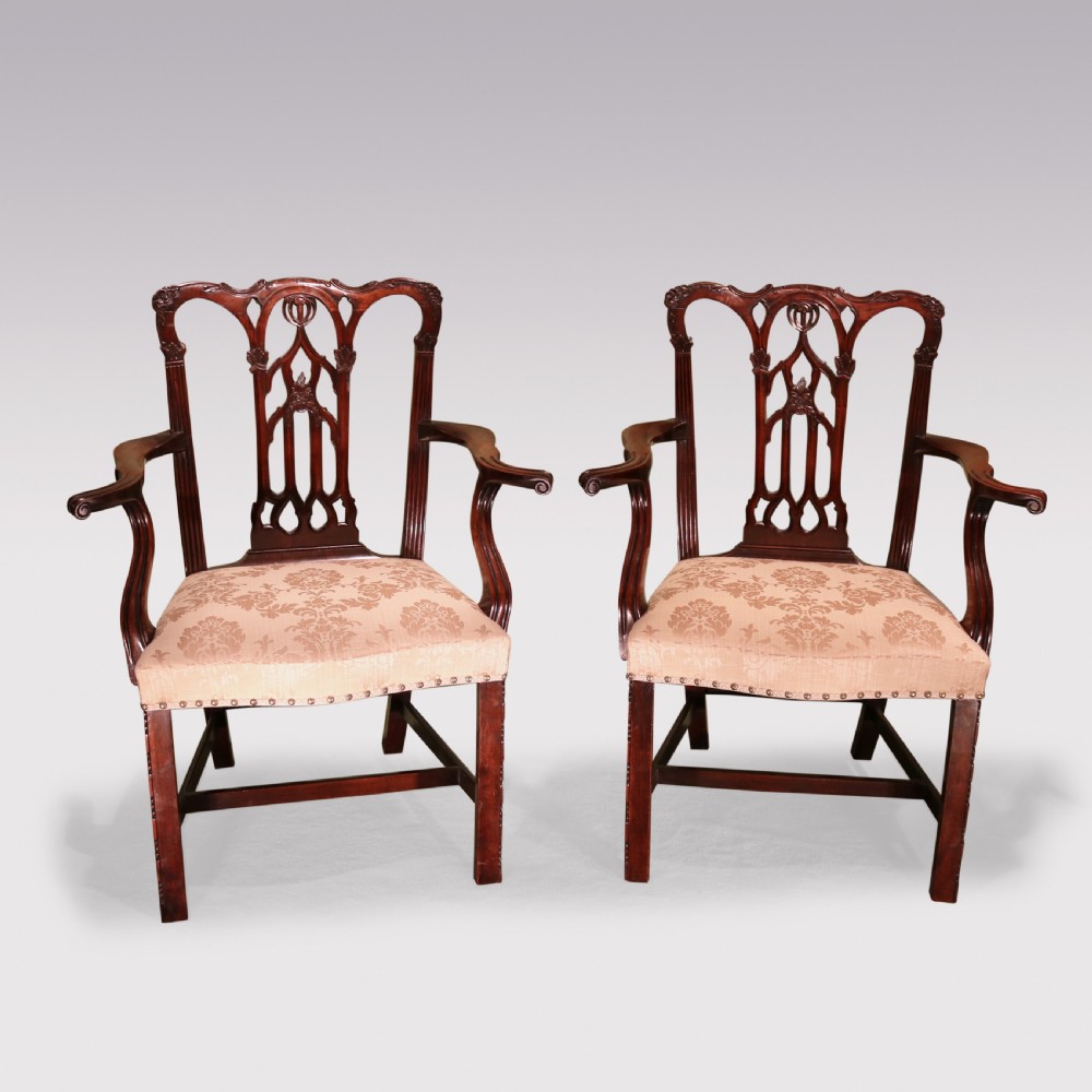 A set of twelve mid-nineteenth-century mahogany dining chairs with pierced Gothic tracery back splats and upholstered damask seats. View IX