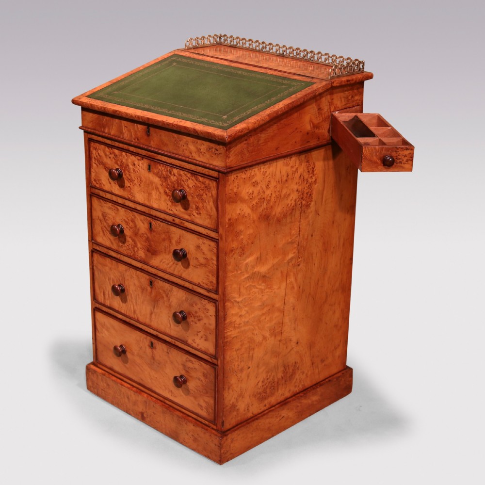 A mid 19th century burr elm Davenport desk featuring a green leather writing slope, brass gallery rail, and four stacked drawers. View II