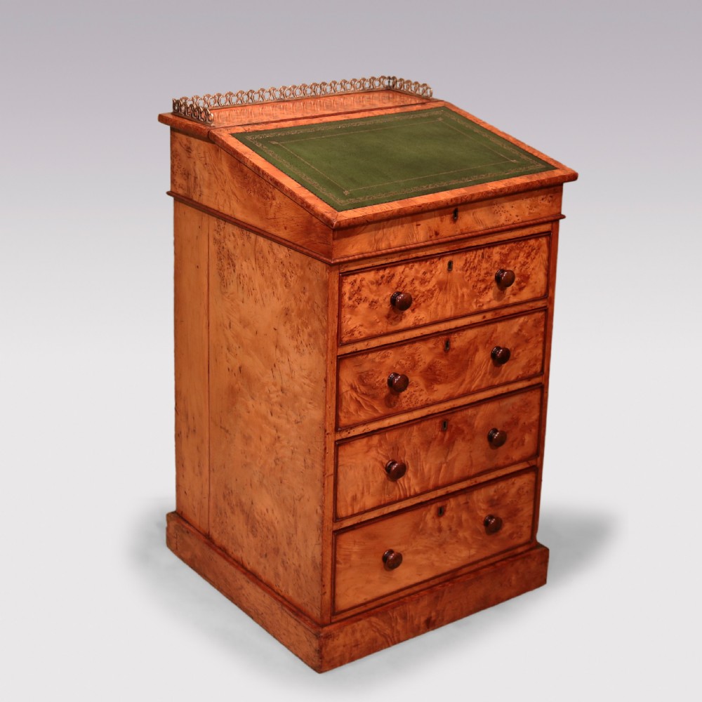 A mid 19th century burr elm Davenport desk featuring a green leather writing slope, brass gallery rail, and four stacked drawers. View VII
