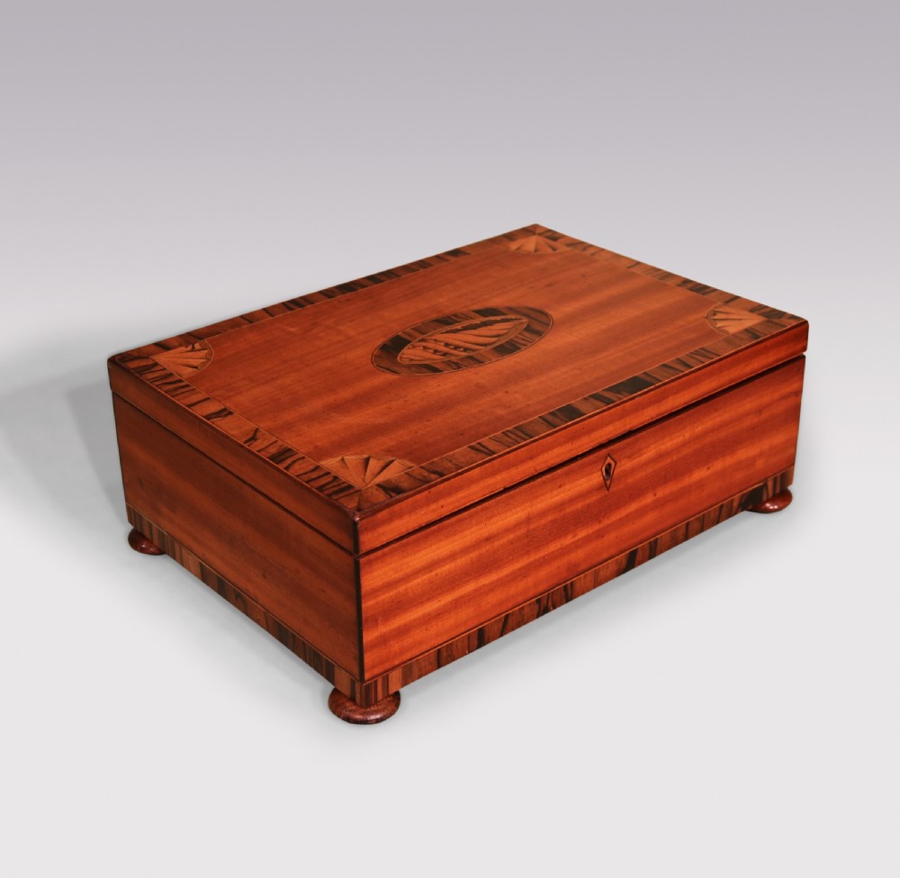 A rectangular George III satinwood box featuring a central oval shell marquetry inlay, fan corner motifs, and striped calamander crossbanding. View III