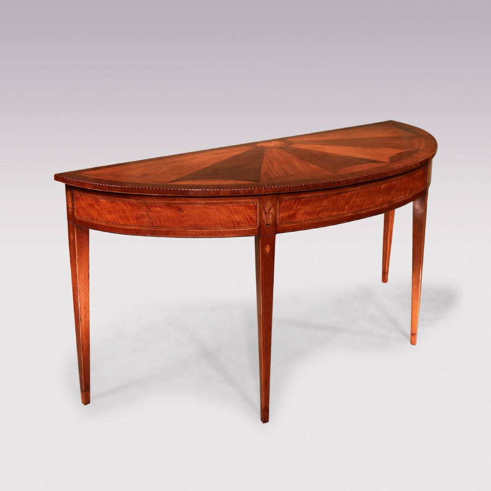 A semi-circular George III satinwood and padoukwood console table featuring a sunburst inlaid top and square tapered legs. View II