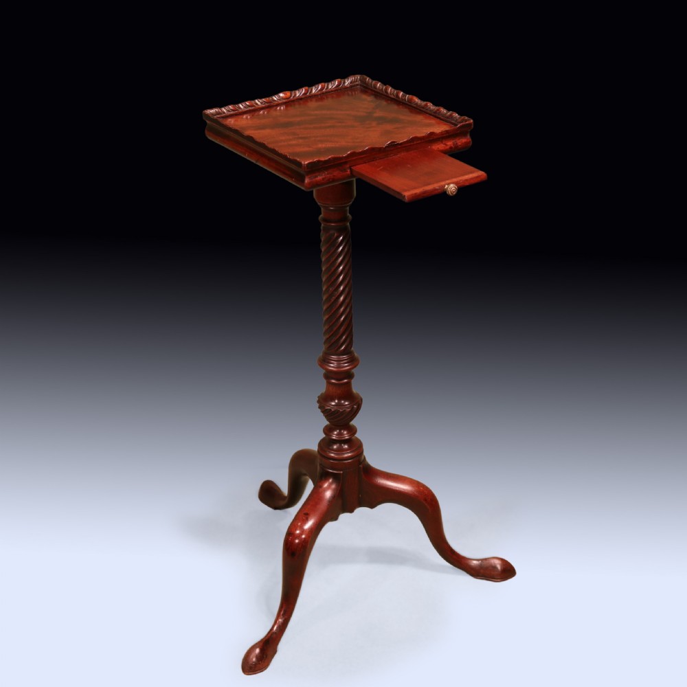 An antique George III mahogany kettle stand featuring a square tray top with a gallery rim, a pull-out slide, a spiral-carved column, and a tripod base. View II