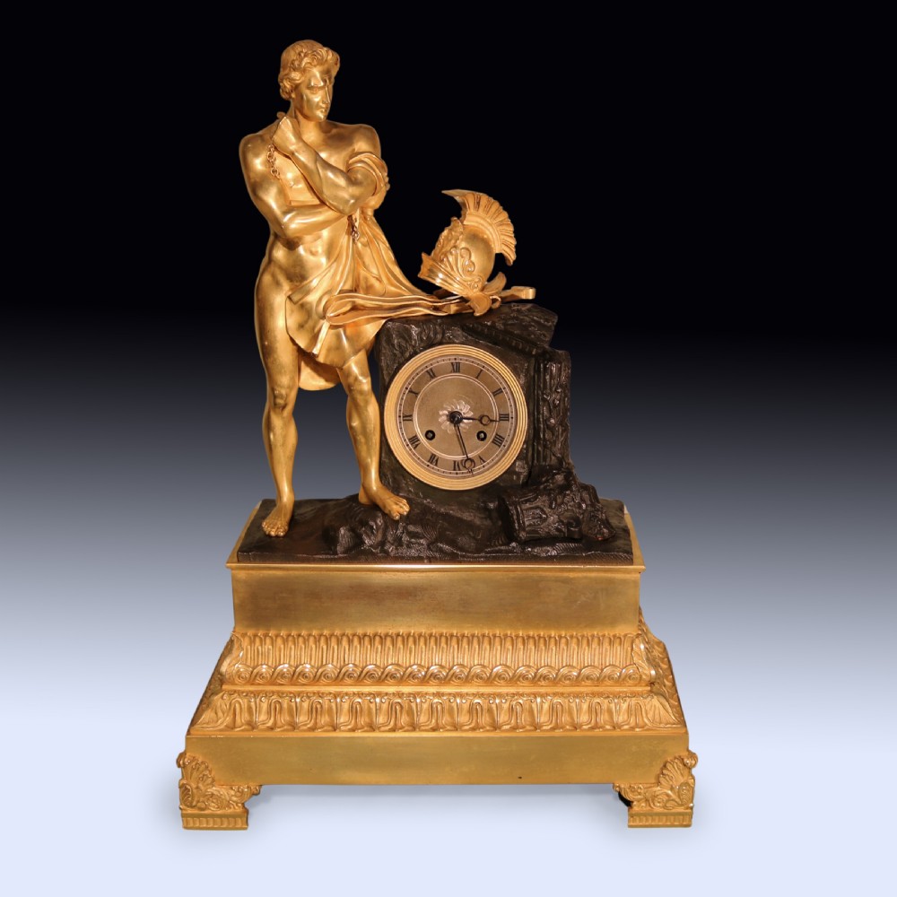 An early 19th-century French Empire gilt bronze and ormolu mantel clock featuring a sculpted classical figure standing beside a dark bronze movement casing.