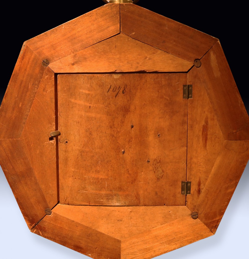 An octagonal nineteenth-century French rosewood wall clock decorated with floral marquetry inlay, a silvered dial with Roman numerals, and a top brass hanging ring. View V