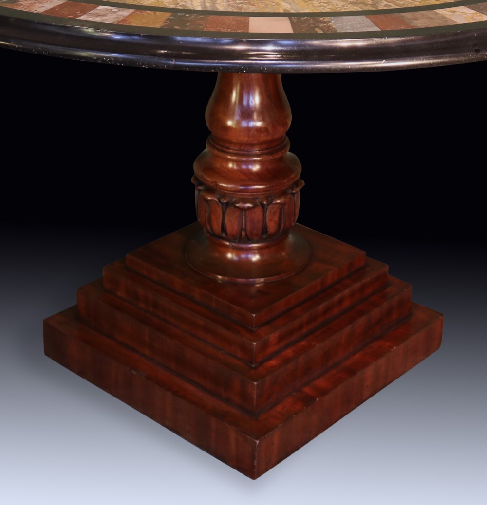A 19th-century round centre table with an inlaid geometric specimen marble top supported by a carved mahogany pedestal base. View II