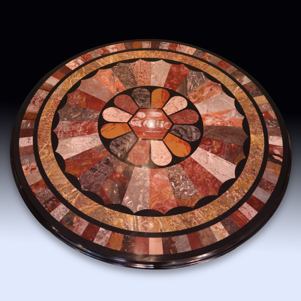 A 19th-century round centre table with an inlaid geometric specimen marble top supported by a carved mahogany pedestal base. View III