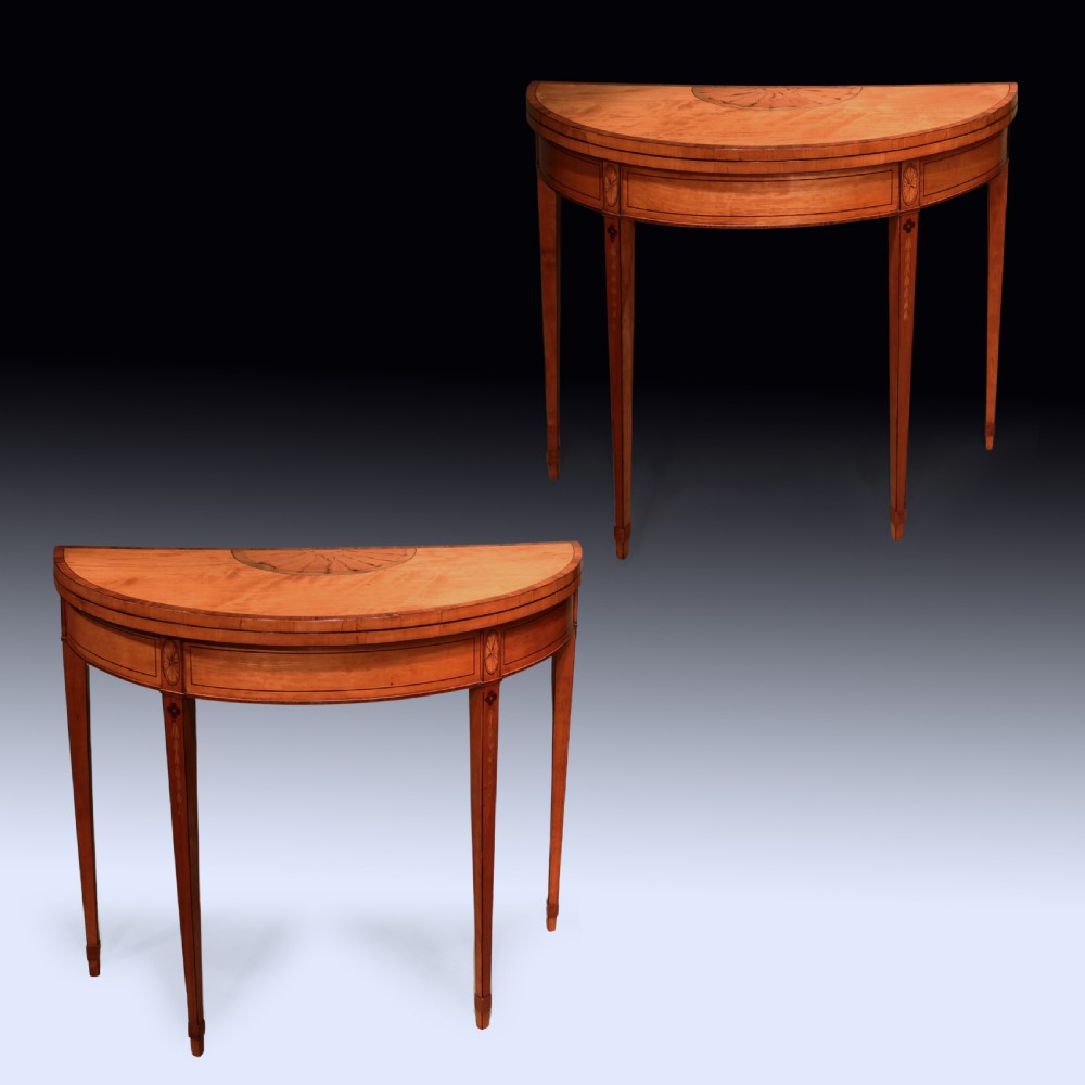 A pair of demilune antique satinwood card tables featuring central fan marquetry inlays and slender tapered legs. View II