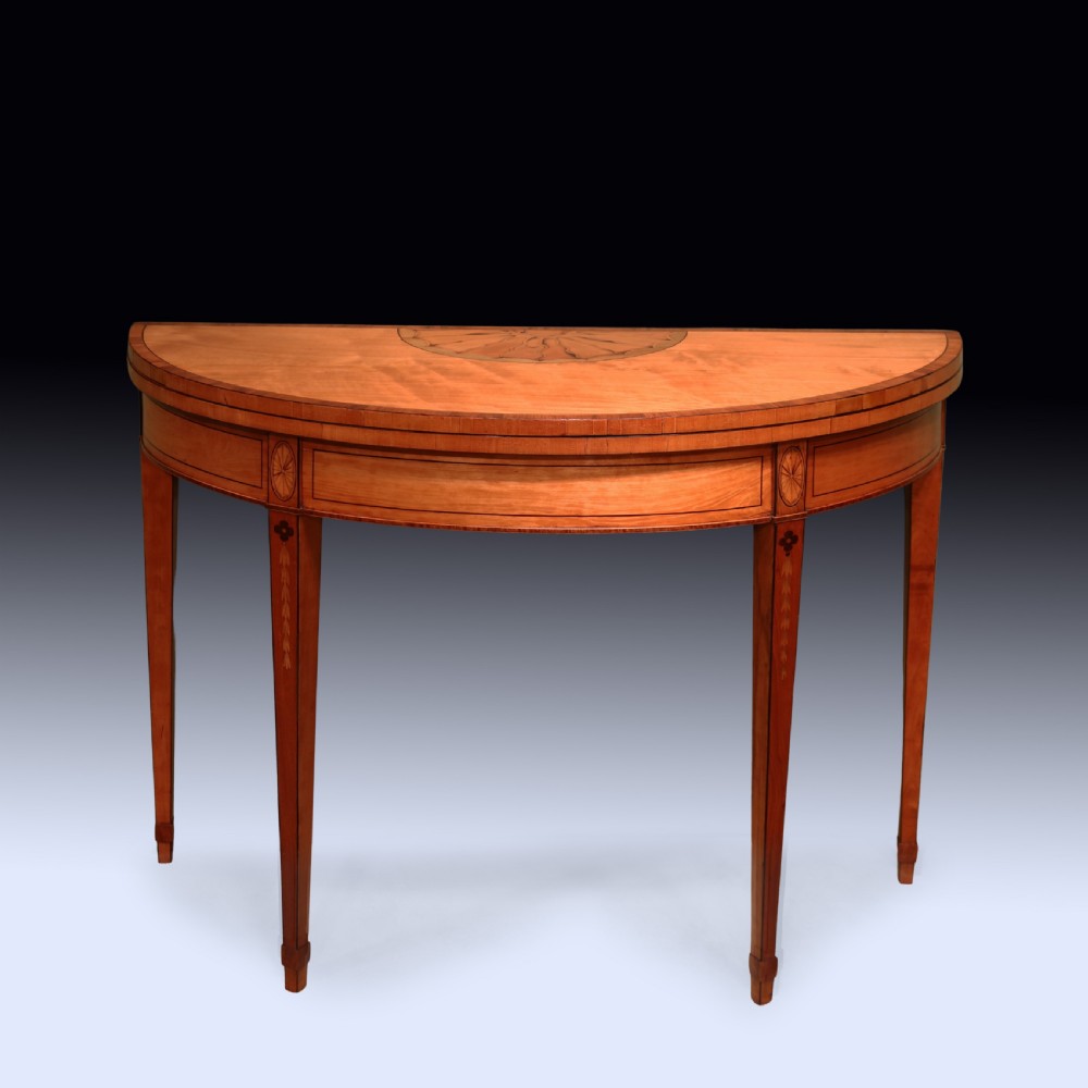 A pair of demilune antique satinwood card tables featuring central fan marquetry inlays and slender tapered legs. View III