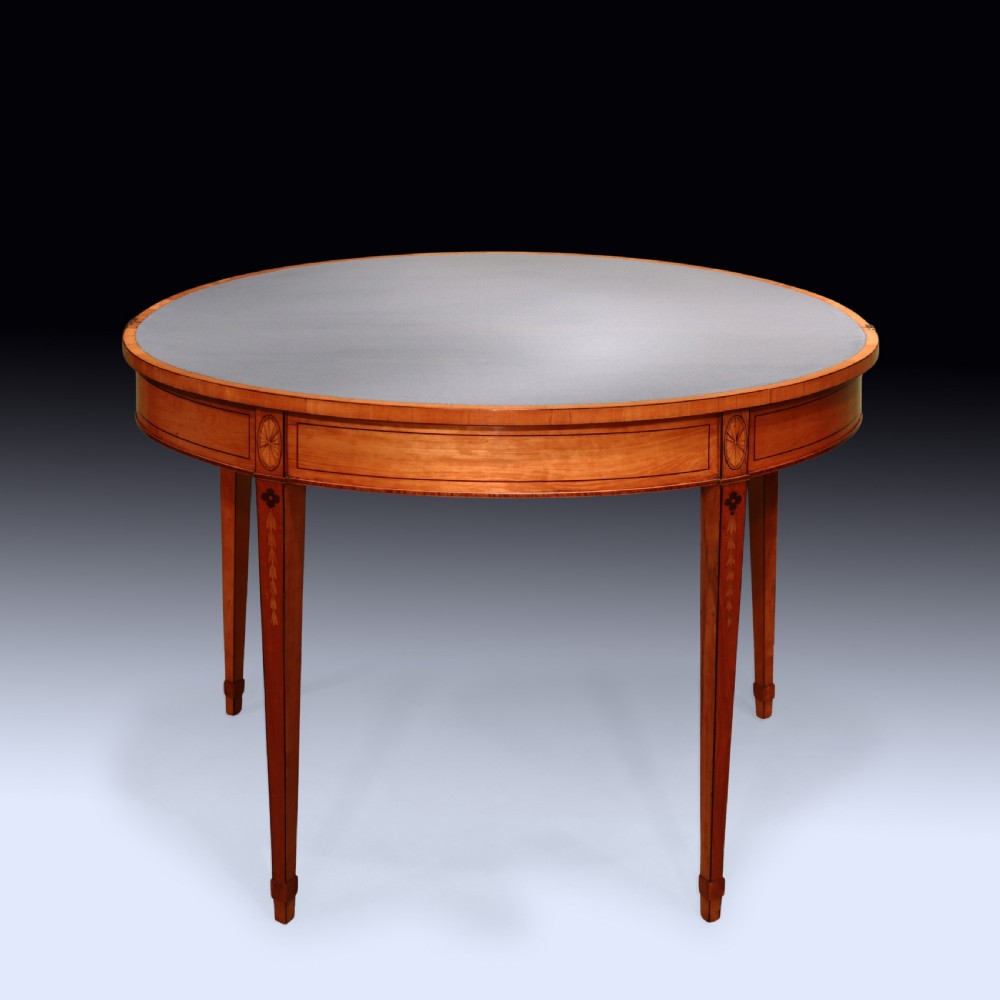 A pair of demilune antique satinwood card tables featuring central fan marquetry inlays and slender tapered legs. View V