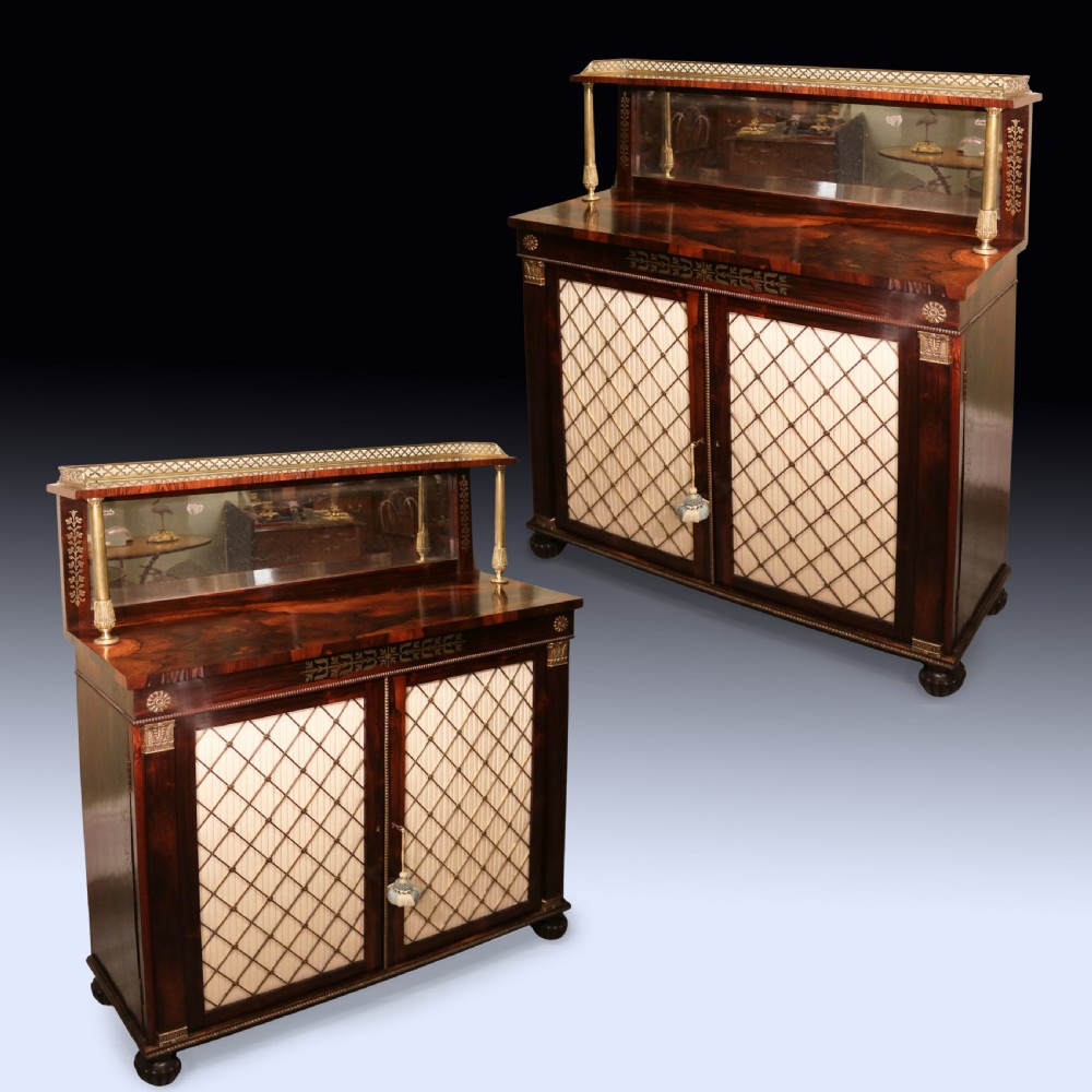 A matching pair of dark rosewood Regency side cabinets featuring brass inlay, mirrored top tiers with brass galleries, and pleated fabric behind brass grilles on the doors. View II
