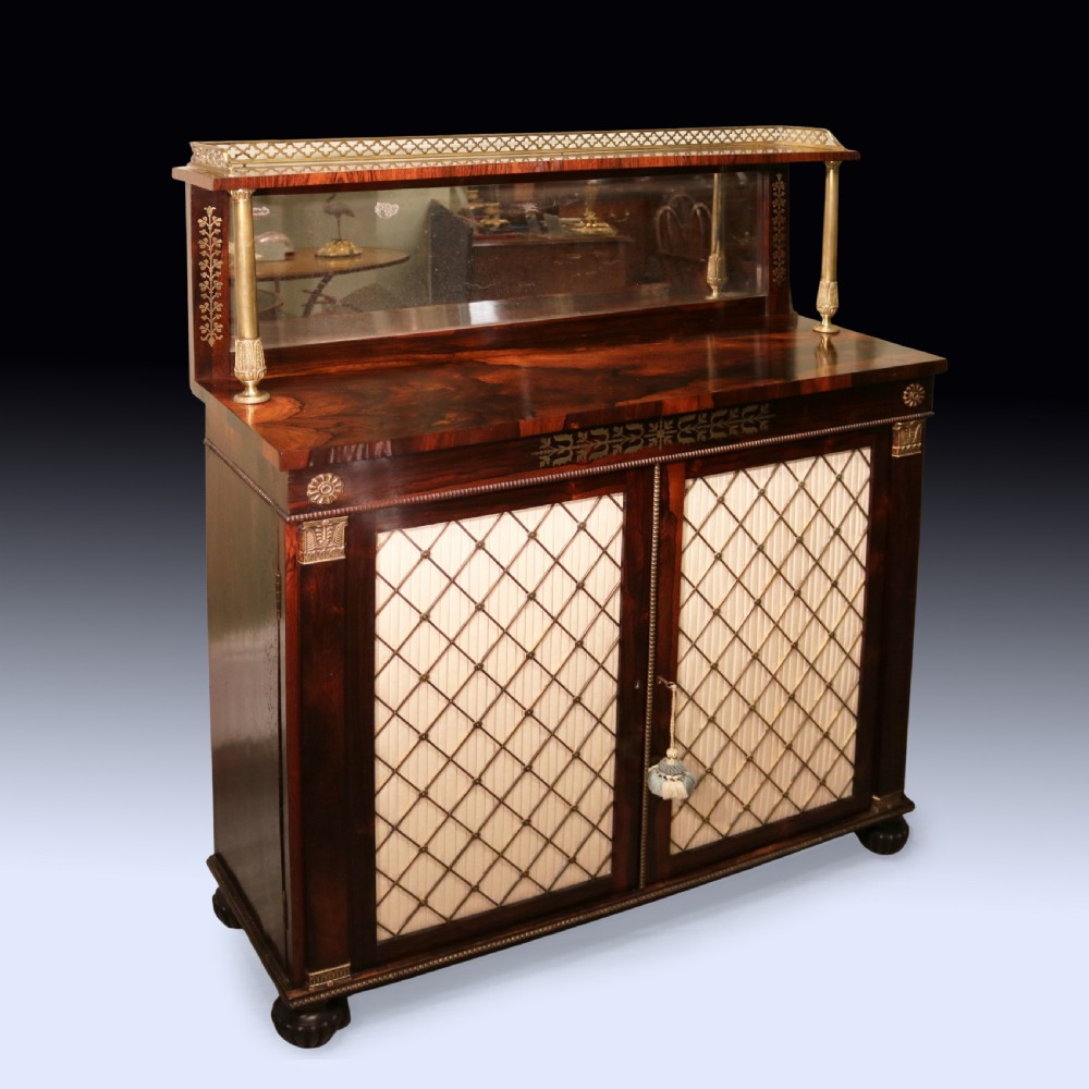 A matching pair of dark rosewood Regency side cabinets featuring brass inlay, mirrored top tiers with brass galleries, and pleated fabric behind brass grilles on the doors. View III