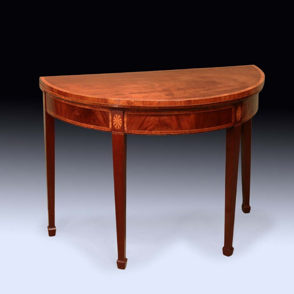 A pair of late 18th-century semi-circular mahogany card tables featuring inlaid rosettes and square tapered legs. View IV