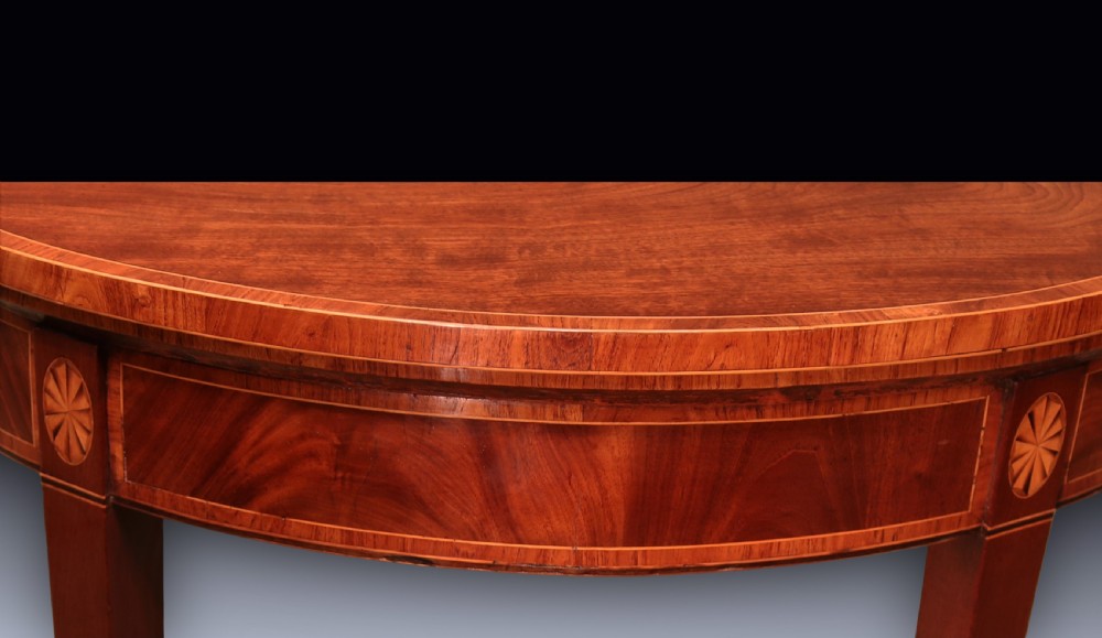 A pair of late 18th-century semi-circular mahogany card tables featuring inlaid rosettes and square tapered legs. View VI