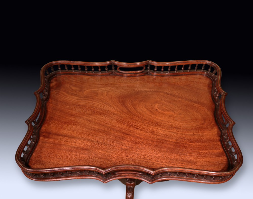 An antique Chippendale style mahogany tripod wine table featuring a rectangular tray top with a spindle gallery and turned pedestal base. View III