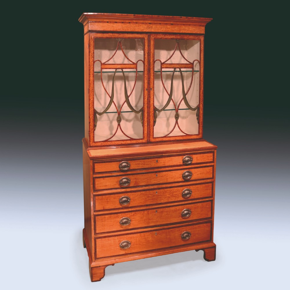 A Sheraton period satinwood secretaire bookcase featuring astagal glazed doors on the upper display cabinet over a chest of drawers. View XI