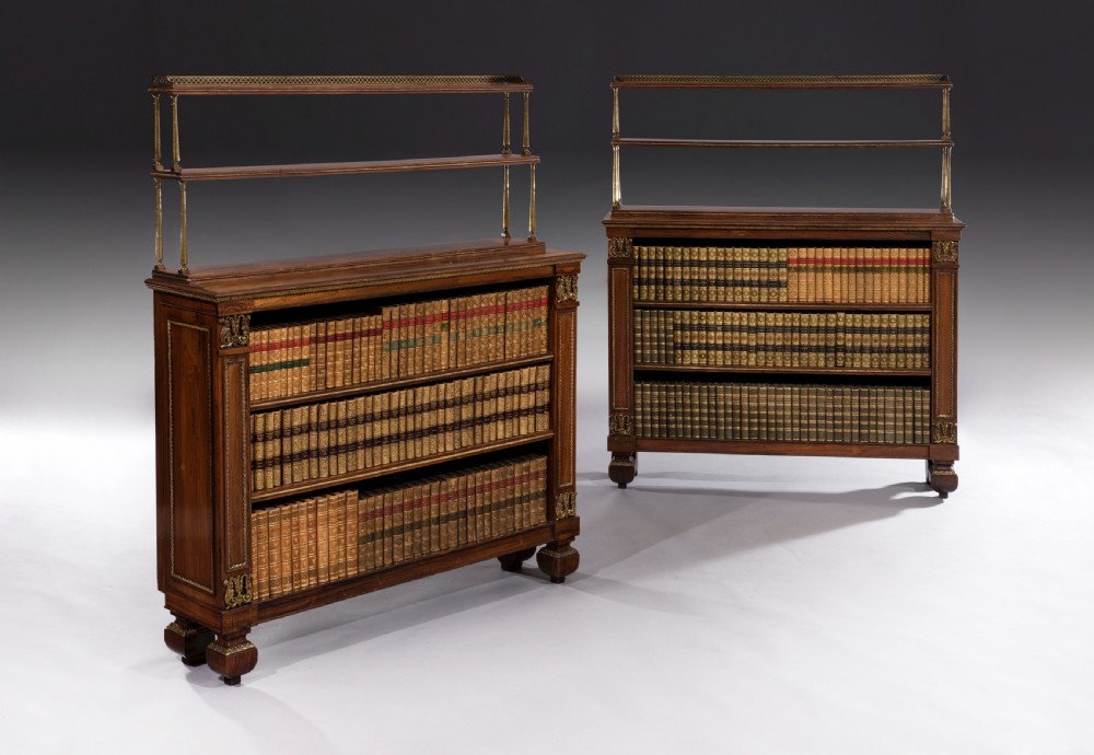 A matching pair of 19th-century Regency dark rosewood open bookcases featuring upper brass tiered shelves and corner mounts. View II