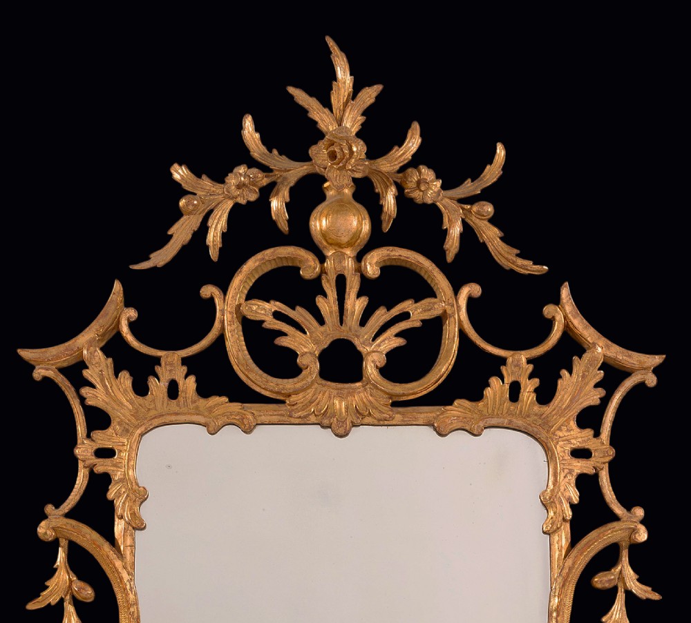 An antique Chippendale period giltwood wall mirror featuring carved openwork rococo frame with C-scrolls and acanthus leaves enclosing a rectangular plate. View II