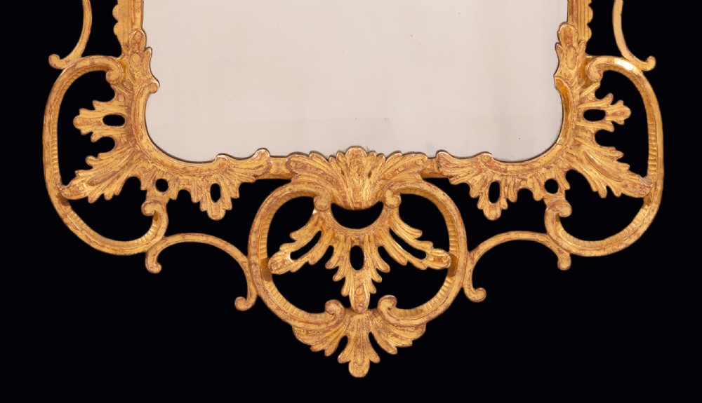 An antique Chippendale period giltwood wall mirror featuring carved openwork rococo frame with C-scrolls and acanthus leaves enclosing a rectangular plate. View III
