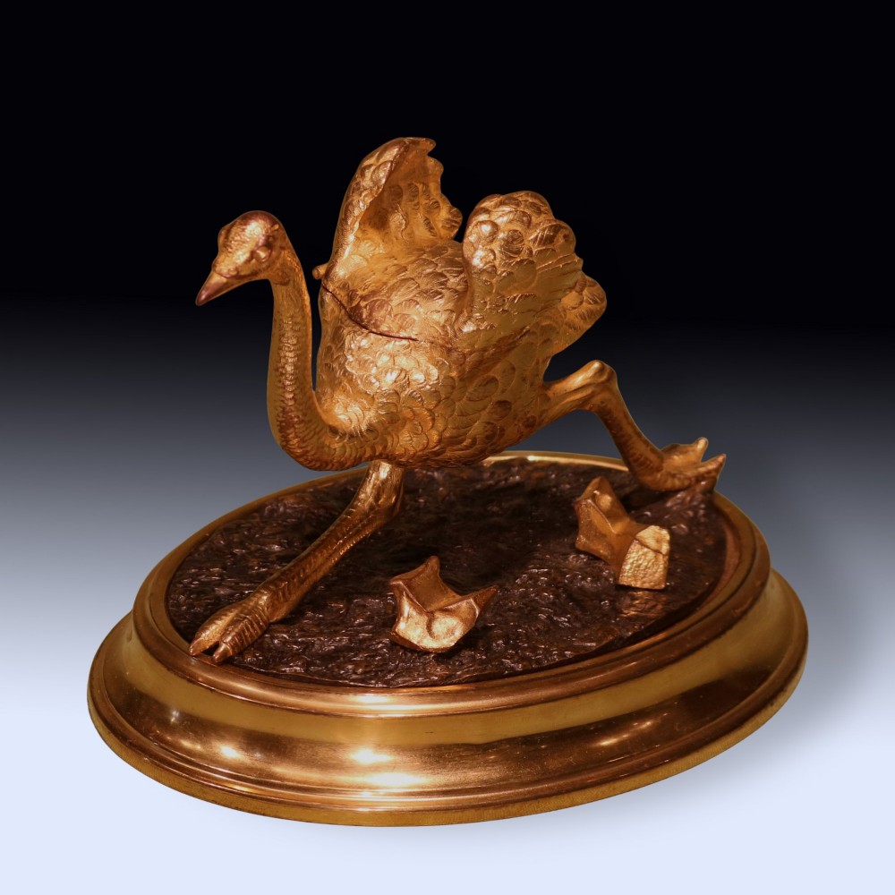 A 19th-century ormolu and patinated bronze inkwell shaped as a striding emu on an oval base.