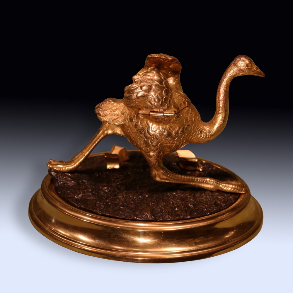 A 19th-century ormolu and patinated bronze inkwell shaped as a striding emu on an oval base. View II
