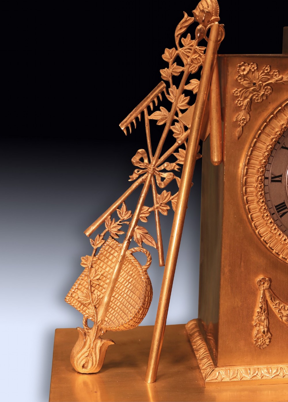 An early 19th-century French gilt bronze ormolu clock featuring a classical female figure standing beside a rectangular housing topped with a fruit basket. View IV