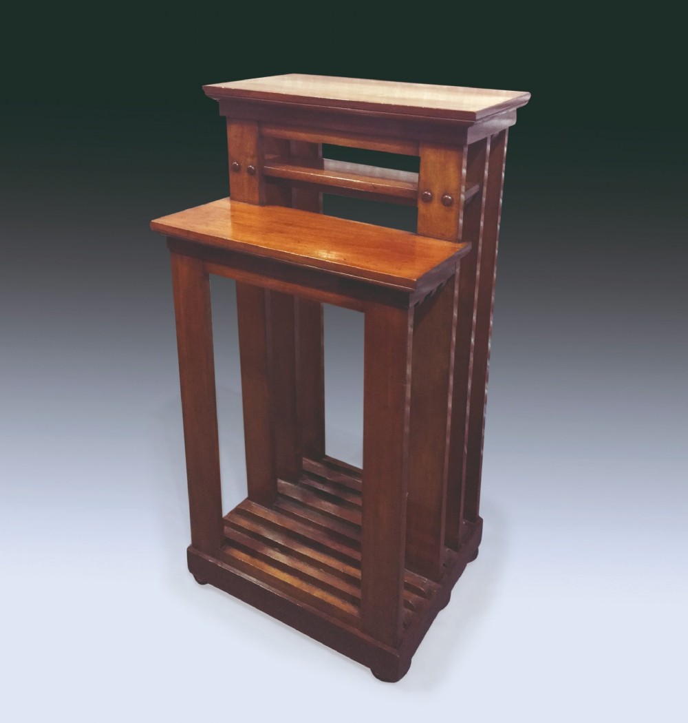 A circular mahogany extending dining table with a thick moulded top resting on a heavily carved central pedestal with four ornate scrolled legs. View V