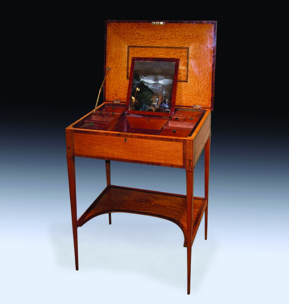 An antique Sheraton period satinwood occasional table featuring a rectangular top with an oval central inlay, a single drawer, tapered square legs, and a concave undertier. View III