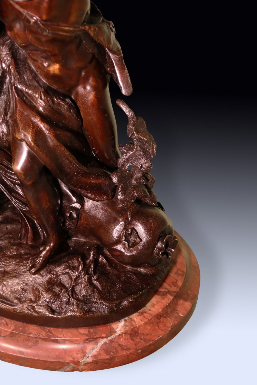 A 19th-century patinated bronze sculpture depicting Bacchanalian classical figures and cherubs mounted on a circular red marble base. View III